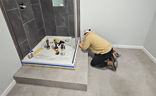 Shower on elevated platform to allow for proper drainage and stability