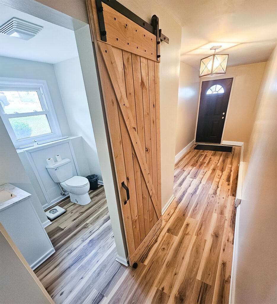 Etters, PA flooded basement restoration and renovation with sliding barn door bathroom