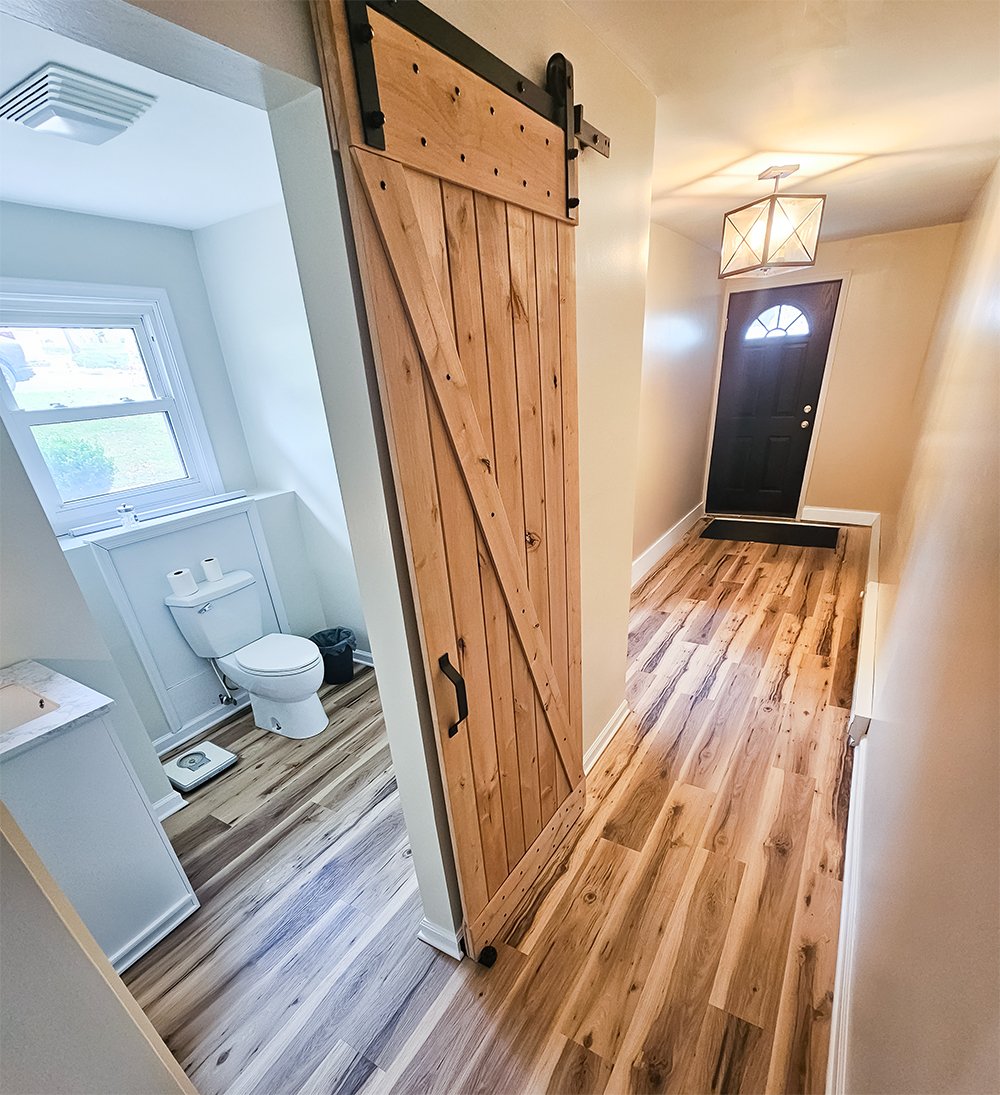 Etters, PA flooded basement restoration and renovation with sliding barn door bathroom
